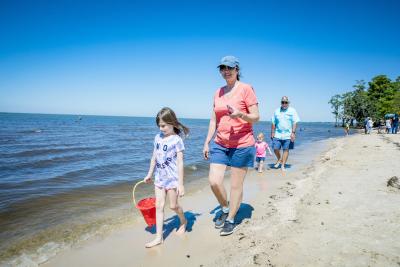 Family walking on beach at Fontainebleau State Park