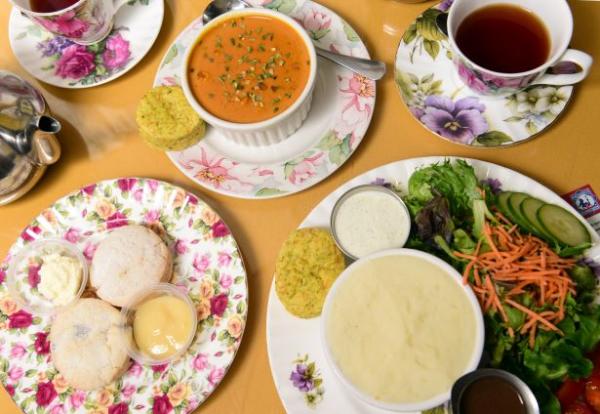 A spread of soups, salads, and pastries on flowered plates from the English Tea Room