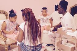 Young girls sit on fancy chairs as they get pedicures at Spoil Me Rott'n Day Spa for Kids, Slidell